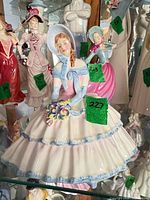 Front view of Royal Doulton Daydreams figurine in cabinet