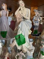 Front view of Royal Doulton Sunset figurine displayed in cabinet