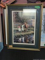 Full view of framed print showing image, matting and gold-tone frame