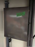 Closed gray metal cabinet mounted on wall