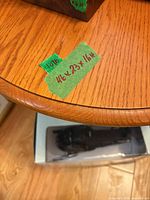 green tape showing written dimensions on table edge