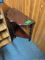 Mahogany finish end table showing top surface, turned legs and lower shelf