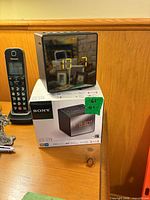 Sony ICF-C1T clock radio atop its box showing mirrored display