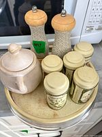 Overview of all items: spice tins, grinders, ceramic jar, lazy Susan
