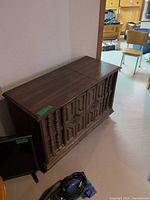 Full view of closed wood console stereo cabinet