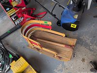 top view of wood slat toboggan with curved side rails and handle inside