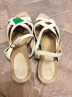 top view of both sandals showing straps, buckle, worn footbeds