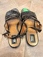 Top view showing both sandals, open toes, straps, size and wear on insoles