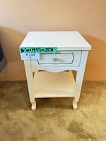 Front view of cream nightstand showing drawer, knob, lower shelf, legs