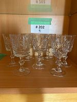 Front view showing all seven pinwheel crystal stemmed glasses on shelf
