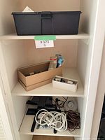 Full closet view of toolbox, boxes, cords and lights