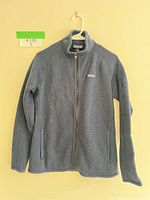 Front view of Patagonia knit fleece jacket showing zipper, pockets and logo