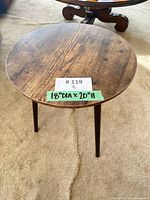 Top view of round table showing veneer surface and size tag