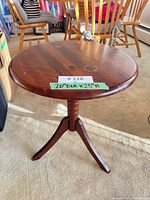 Full view of wooden tripod pedestal table