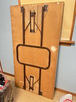 Underside view showing folding metal legs and wear