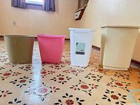 Group shot of all four plastic bins lined up on floor