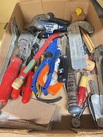 Overview of box contents showing variety of hand tools