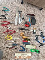Full layout of assorted hand tools on carpet