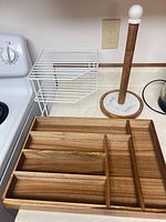 All three items on countertop: wood drawer organizer, white metal shelf, wood & stone paper towel holder