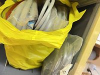 Grey foam backer rods in yellow bag on shelf
