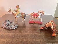 All four figurines on tabletop