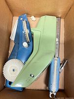 Three label makers and loose wheels in box