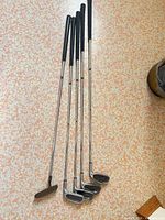 Five clubs laid out – four irons and one putter