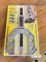 Front of sealed retail blister pack showing iGaging Digital Multi Gauge, product features and LCD display