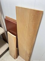 Group of assorted boards leaning against wall