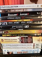 Left stack of 13 DVD spines with titles visible