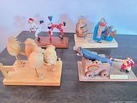 Group shot of all four carved wood sculptures on display