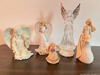Group shot of all five angel figurines on tabletop