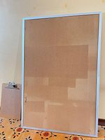 Full view of cork bulletin board with clipboard beside it
