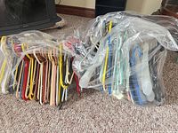 Bag containing large quantity of multicolor clothes hangers