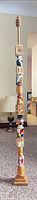 full view of entire carved pole standing