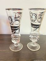 Pair of flutes front view showing 25th anniversary script and silver trim
