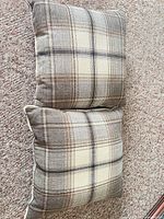 Top view of both plaid pillows showing pattern and overall condition
