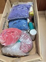 Open box showing red, purple and blue pellet bags plus bottles