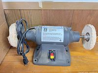 Full view of bench buffer showing both buffing wheels, body, switch and cord