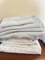 Stacked light gray and white sheets