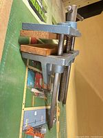 Side view of RAE cast iron clamp with wood-faced jaws and screw mechanism