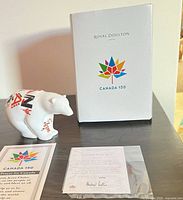 Figurine with box and paperwork