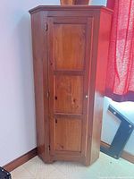 Front view of solid wood corner cabinet