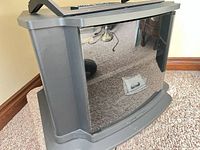 Front view of Sony black metal TV stand with curved smoked glass door