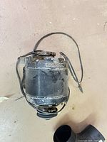 Full view of motor showing housing, wiring, pulley end