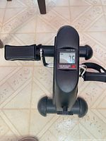 Top view of TOPO mini pedal exerciser showing LCD display and pedals
