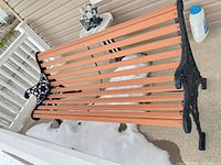 Full view of bench showing cast-iron end and wood slats