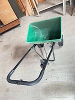 Full view of spreader showing hopper, handle, frame and wheels