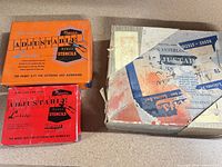 Three stencil kit boxes, two orange Reese's and one wrapped Hanson