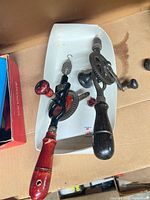 Both hand crank drills in tray